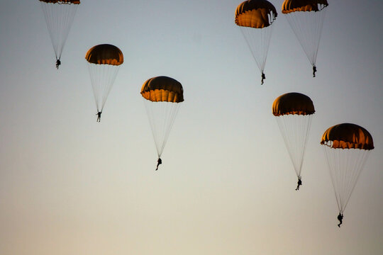 the plane threw off paratroopers who opened their parachutes and fly down