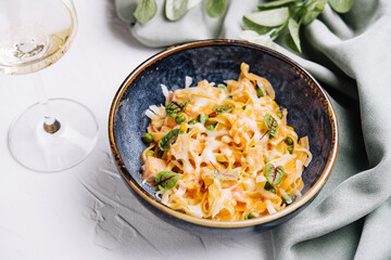 pasta with salmon and peas with wine glass