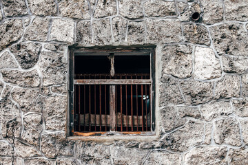 old wooden window in stone wall