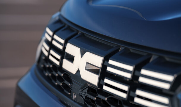 Dacia Duster. The new logo sign of Dacia company, part of Renault Group, after rebranding, in front of a Duster SUV car. Romania, 2023.