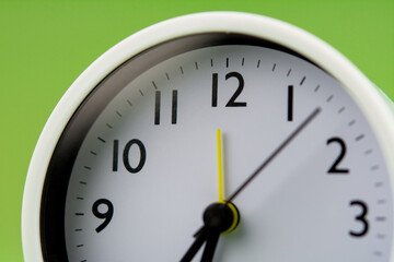 Alarm clock on green background, time concept, clock photo