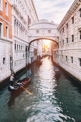 Fototapeta na wymiar Gondola on canal with the Bridge of Sighs in Venice, Italy