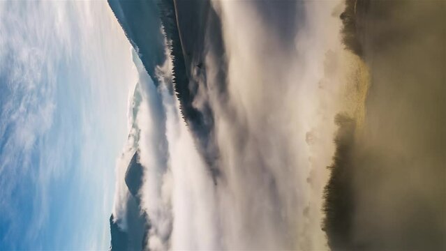 Vertical video Magic morning with fogy clouds motion fast in autumn nature Hyper Aerial Time lapse