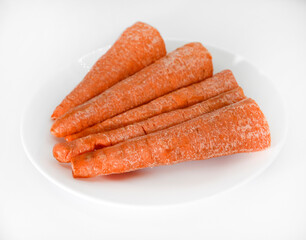 Peeled fresh carrots on a white background. Delicious fresh carrots. Fresh vegetables on the table.