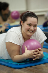 Woman, pilates ball and smile