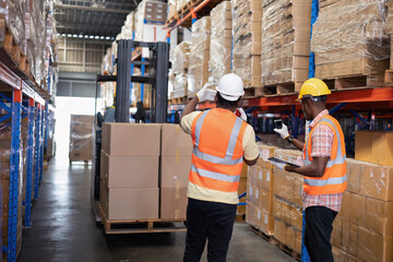 Worker in depot storage warehouse use tablet pc check scan barcode goods box and store on shelf