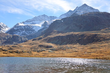 Fototapeta na wymiar View on the Bianco Lake which is a reservoir at the Bernina pass in the Swiss canton of Graubünden