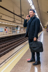 Middle-aged Caucasian businessman waiting on the subway for the train to go to work