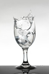 water splashing out of wine glass.
