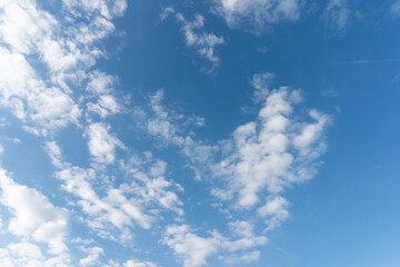 Small clouds lined up and a beautiful blue sky.