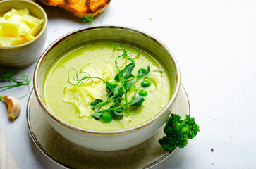 Pea Soup with Green Vegetables, Broccoli and Pea Sprounts with cheese on bright backround
