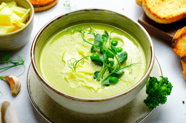 Pea Soup with Green Vegetables, Broccoli and Pea Sprounts with cheese on bright backround