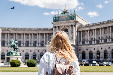 Woman looking to Hofburg in Vienna. Tourist traveling in Austria