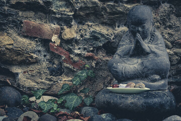 Praiyng Buddha in a stone garden