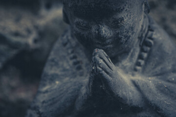 Close up of a praiyng Buddha statue
