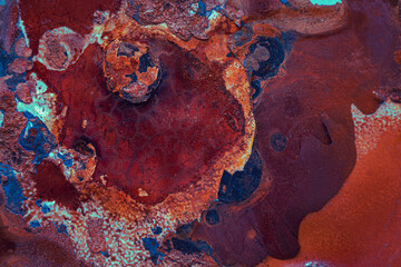 Abstract macro view of the paint and rust on the body of a car