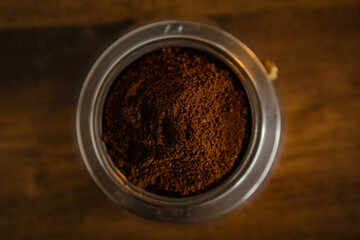 An interesting photo of ground coffee in a coffee maker.  Artistic noise and grain