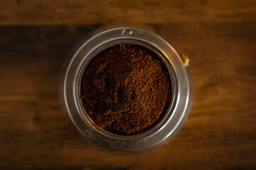 An interesting photo of ground coffee in a coffee maker.  Artistic noise and grain