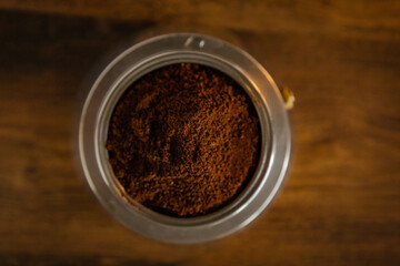 An interesting photo of ground coffee in a coffee maker.  Artistic noise and grain