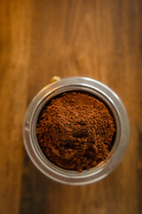 An interesting photo of ground coffee in a coffee maker.  Artistic noise and grain