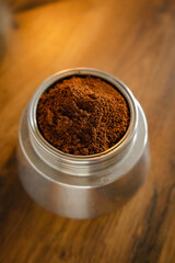 An interesting photo of ground coffee in a coffee maker.  Artistic noise and grain