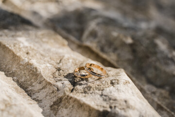 wedding rings close-up on a stone
