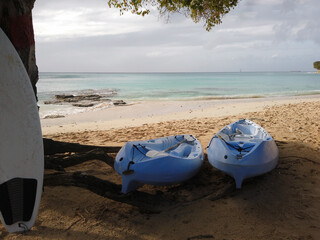 Kayaks and Surfboard for recreation on the beach.