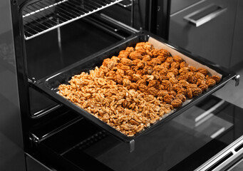 Roasted baked walnuts close up on a baking sheet