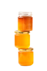 Jars with honey one on top of the other on a white background