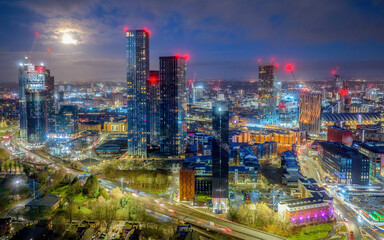 Fototapeta na wymiar Deansgate Square Manchester England, construction building work at dawn with city lights and dark skies of this Northern English city centre aerial view