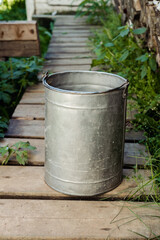 Naklejka premium iron bucket with water in the country in the summer