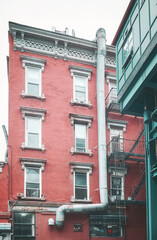 New York old brick townhouse, retro toning applied, USA.