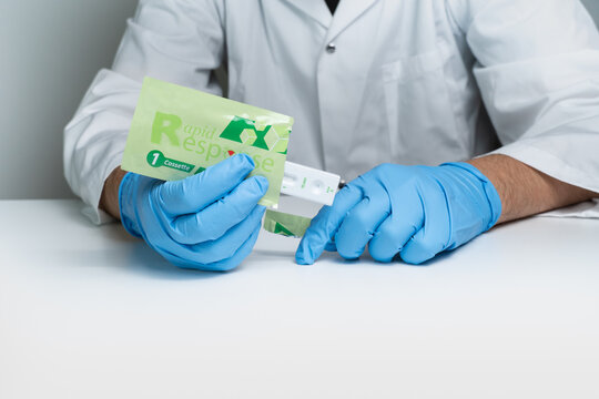 Toronto, Ontario, Canada - December 30, 2022: Male Nurse Holding Covid 19 Rapid Test Kit Given To Shoppers At Grocery Stores And Pharmacies Across The Province. Rapid Antigen Test Package Kit.