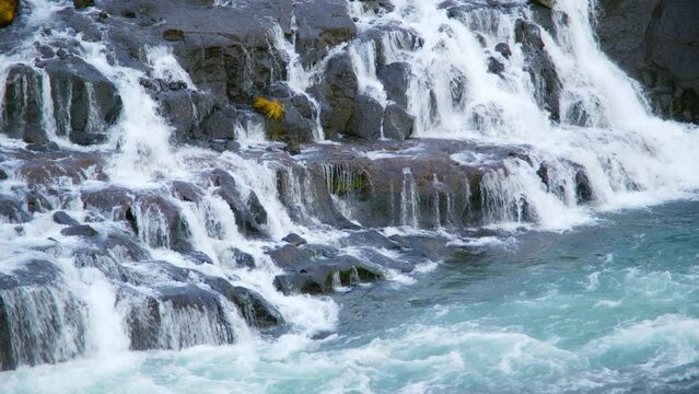 Autumn Waterfall in Iceland. Pure Turquoise Water in Mountain River. Popular Tourist Spot. Famous Travel Destination. Beautiful Nature, Unusual Landscape. Footage Shot in 8K Resolution 4320p