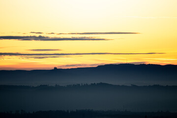 dawn before sunrise in germany swabia with hohenzollern castle at the horizon