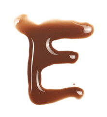 Spilled chocolate milk puddle in shape letter E isolated on white background, top view
