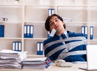 Young tied male employee in the office