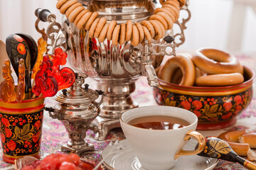 Russian traditions. Tea drinking with a samovar. Still life with a cup of tea, bagels, dried...