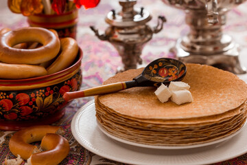 Russian traditions. Russian holiday Maslenitsa. Still life with a cup of tea, a stack of pancakes,...