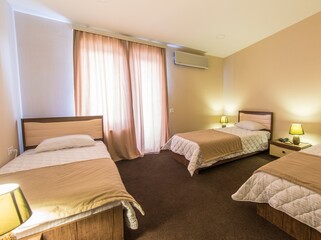 Fototapeta na wymiar Triple room in modern hotel