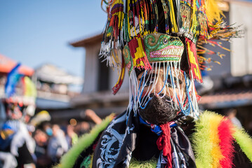 Fototapeta premium Chinelo or Chinelos are a traditional colorful costumed dancer in carnaval, is popular in the Mexican state of Morelos near Tepoztlan , State of Mexico and Mexico City, Milpa Alta and Xochimilco.