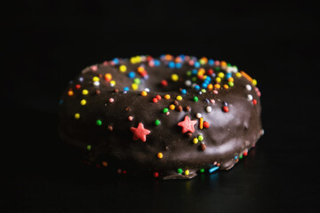 Chocolate donut with glaze black background
