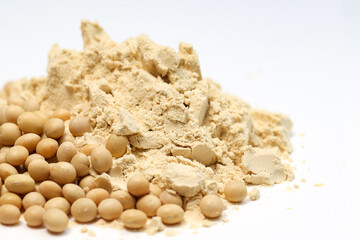 Closeup pile of Soybeans powder together with soybeans seeds isolated on white background, copy space