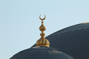 A golden crescent at the top of a mosque. Icon of islam
