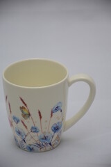 Colorful set of White Ceramic Tea or Coffee mug with Blue red flowers and butterflies on it , isolated on white background