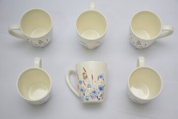 Colorful set of White Ceramic Tea or Coffee mug with Blue red flowers and butterflies on it , isolated on white background