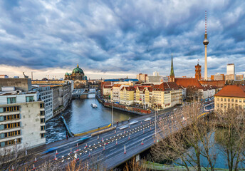 Aerial shot of Berlin Cathedral, Spree canal and historic buildings during a dramatic sky cloud, Germany © Arnold