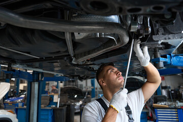 Worker replacing car parts in tire shop