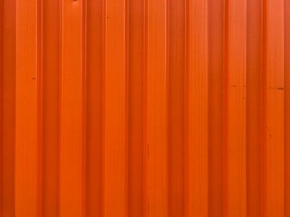 an orange angular corrugated metal wall