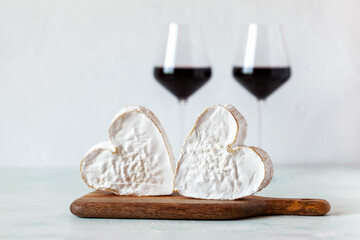 Soft heart shaped cheese and red wine glasses, Valentine Day concept
